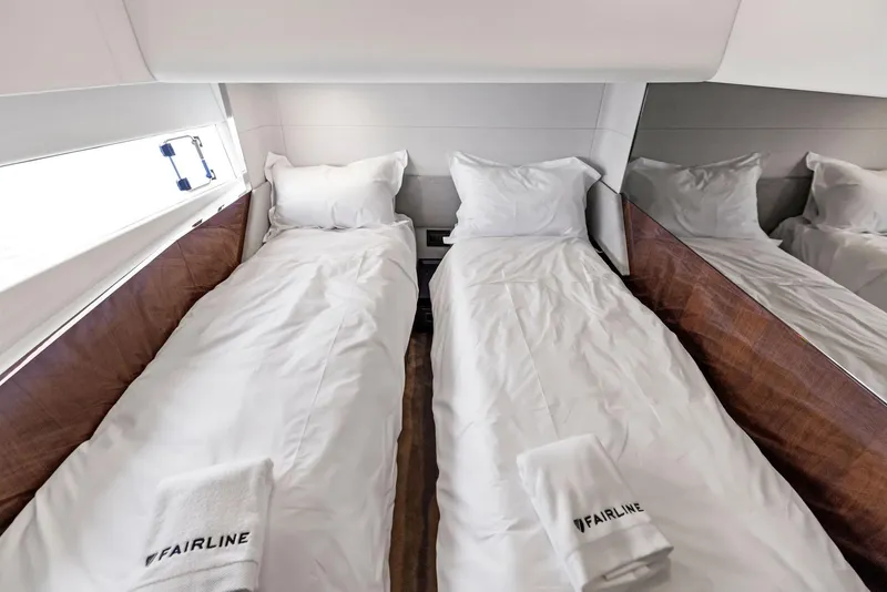 Slide: The Image of Twin beds in the luxurious 2024 Fairline Phantom 65 yacht cabin. - 20