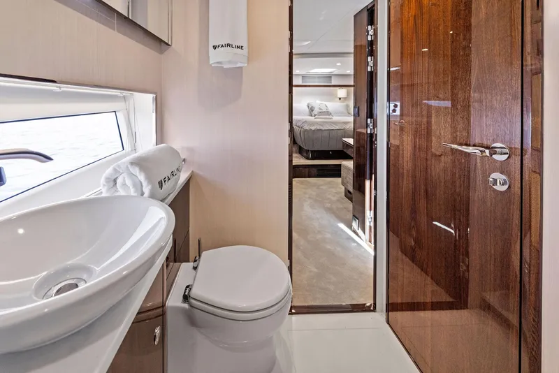 Slide: The Image of Luxurious bathroom interior of 2024 Fairline Phantom 65 yacht, featuring modern fixtures and elegant design. - 24