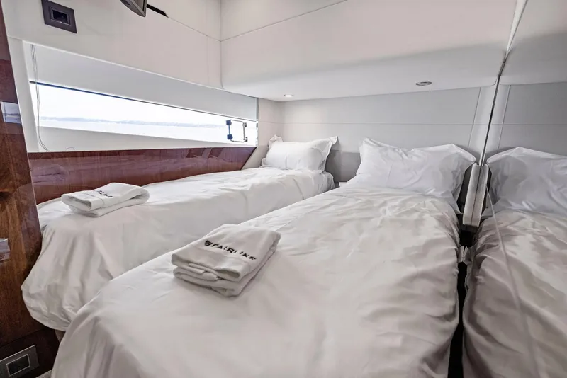 Slide: The Image of Luxurious twin cabin in 2024 Fairline Phantom 65 yacht, featuring elegant bedding and modern design. - 27