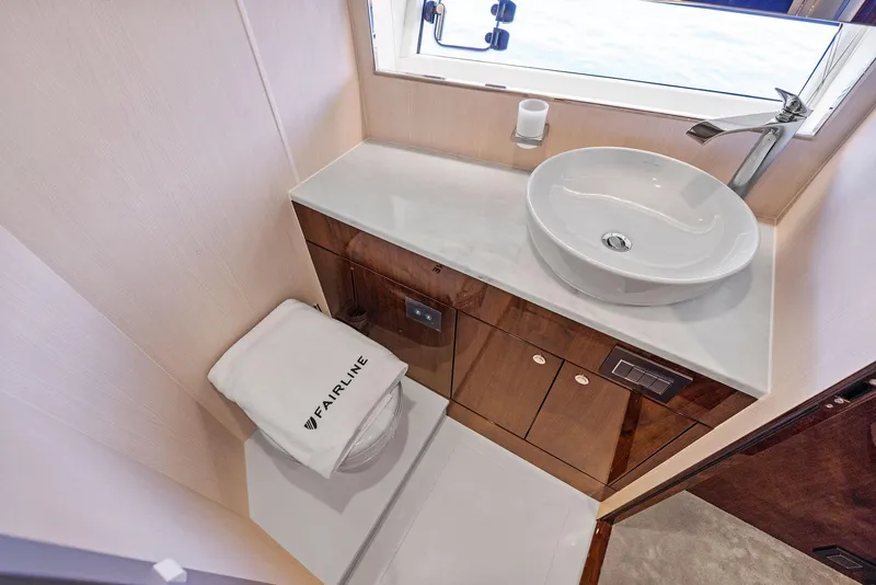 Slide: The Image of Luxurious bathroom in 2024 Fairline Phantom 65 yacht with modern sink and elegant wood cabinetry. - 32