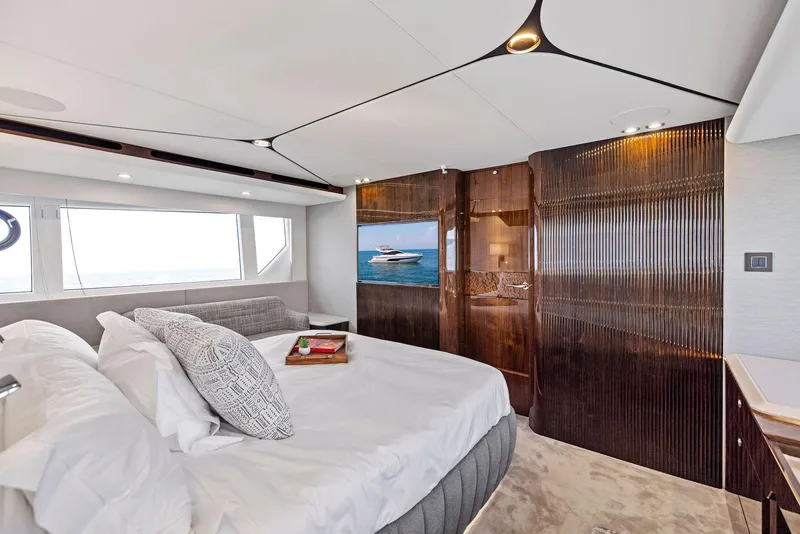 Slide: The Image of Luxurious bedroom interior of 2024 Fairline Phantom 65 yacht with elegant wood finishes. - 36