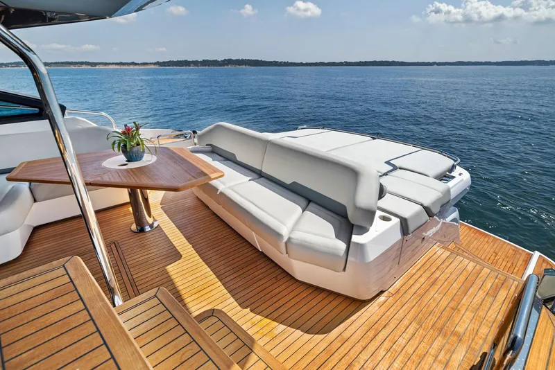 Slide: The Image of Luxurious 2024 Fairline Phantom 65 yacht deck with seating, table, and ocean view. - 9