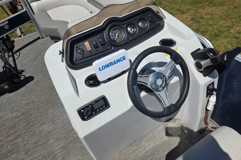 Slide: The Image of 2021 Godfrey Sweetwater 1880 FX boat dashboard with steering wheel and Lowrance electronics. - 12