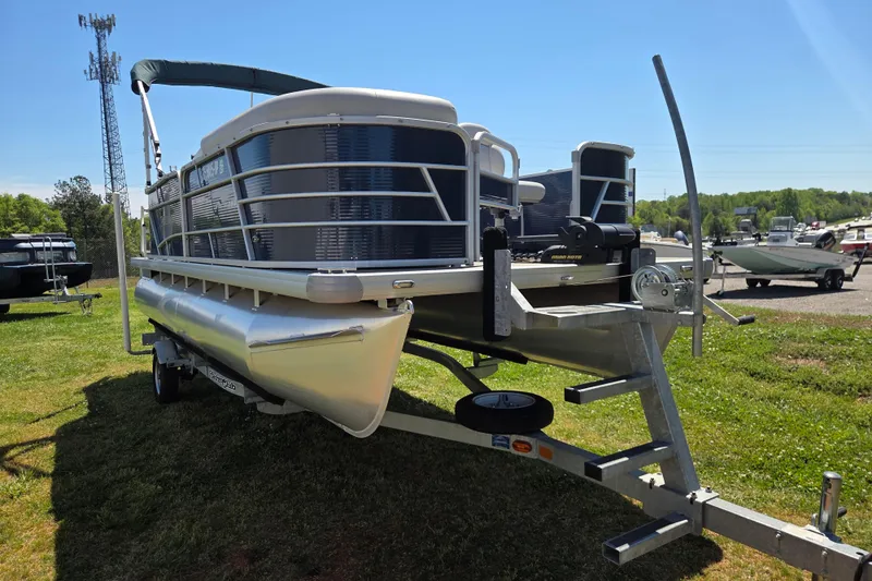 Slide: The Image of 2021 Godfrey Sweetwater 1880 FX pontoon boat on trailer, parked on grass. - 2