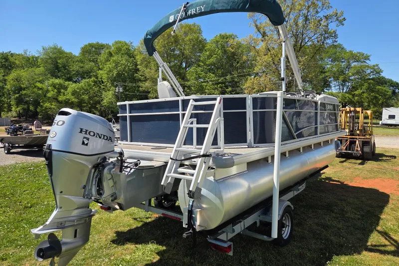 Slide: The Image of 2021 Godfrey Sweetwater 1880 FX pontoon boat with Honda engine on trailer. - 4