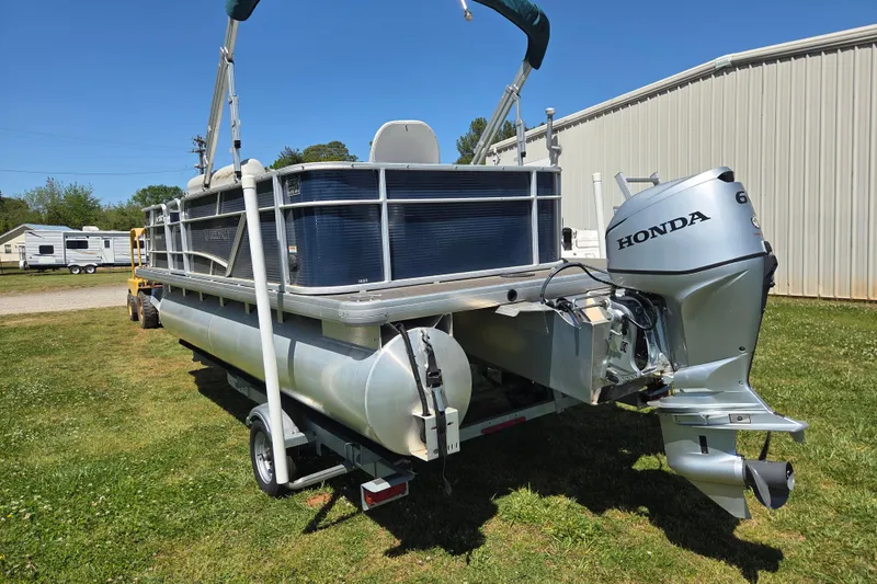 Slide: The Image of 2021 Godfrey Sweetwater 1880 FX pontoon boat with Honda outboard motor on grass. - 5