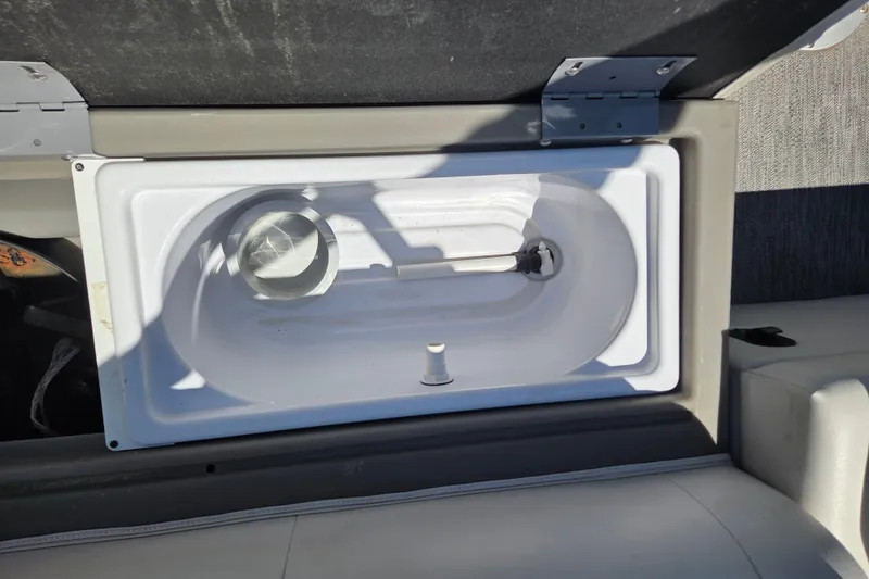 Slide: The Image of Open storage compartment in 2021 Godfrey Sweetwater 1880 FX boat, featuring a white interior. - 8