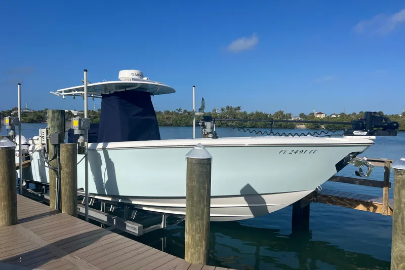 The Image of 2024 Contender 35 ST boat docked by the water on a sunny day. - 1