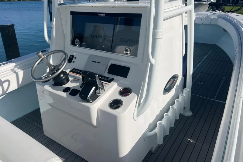 Slide: The Image of 2024 Contender 35 ST boat console with Garmin navigation and Mercury controls. - 10
