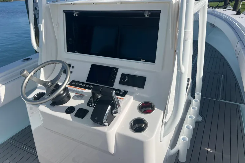 Slide: The Image of 2024 Contender 35 ST boat console with steering wheel and electronic controls. - 11