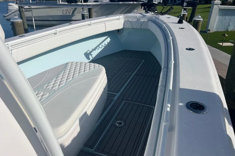 Slide: The Image of 2024 Contender 35 ST boat interior with cushioned seating and sleek deck design. - 12