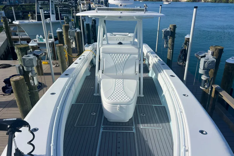 Slide: The Image of 2024 Contender 35 ST boat docked, showcasing sleek design and spacious deck. - 14