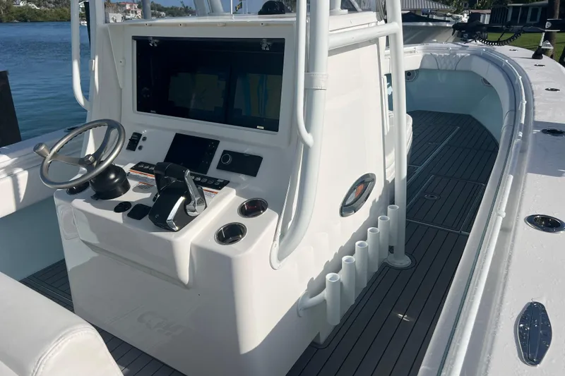 Slide: The Image of 2024 Contender 35 ST boat cockpit with steering wheel and control panel. - 16