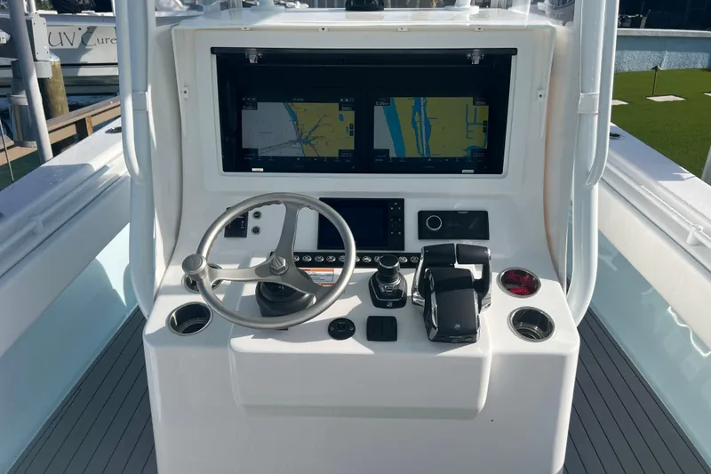Slide: The Image of 2024 Contender 35 ST boat helm with steering wheel and navigation display. - 18