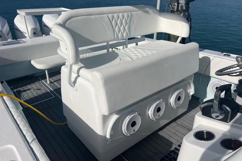 Slide: The Image of 2024 Contender 35 ST boat interior with white seating and marine speakers. - 20