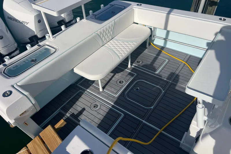 Slide: The Image of 2024 Contender 35 ST boat deck with seating, Mercury engines, and modern flooring. - 26