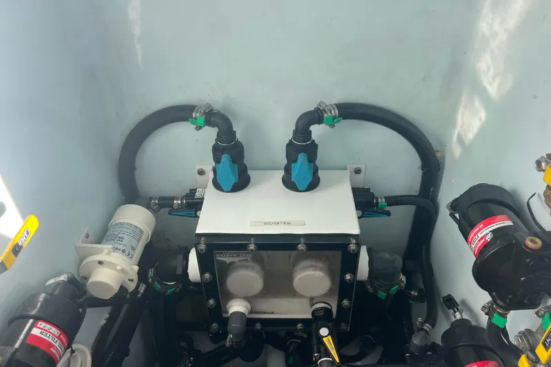 Slide: The Image of Engine compartment of 2024 Contender 35 ST boat, showcasing hoses and mechanical components. - 28