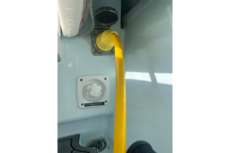 Slide: The Image of Yellow hose connected to a 2024 Contender 35 ST flush pump system. - 31
