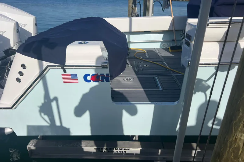 Slide: The Image of 2024 Contender 35 ST boat docked, featuring deck details and American flag decal. - 4