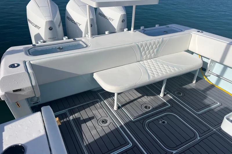 Slide: The Image of 2024 Contender 35 ST boat with Mercury engines, featuring a sleek seating area and modern deck design. - 8