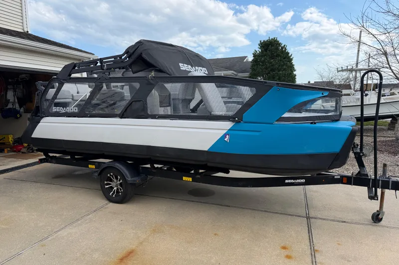 Slide: The Image of 2022 Sea-Doo Switch Cruise 21 on trailer, parked in driveway, showcasing sleek design and vibrant colors. - 5