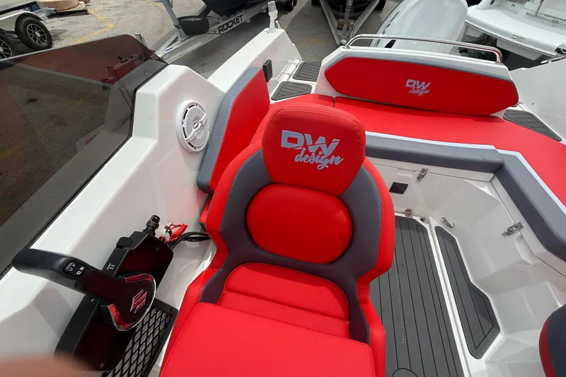 Slide: The Image of Red and gray interior of 2025 Custom DW DESIGN 570BR boat with branded seating. - 11