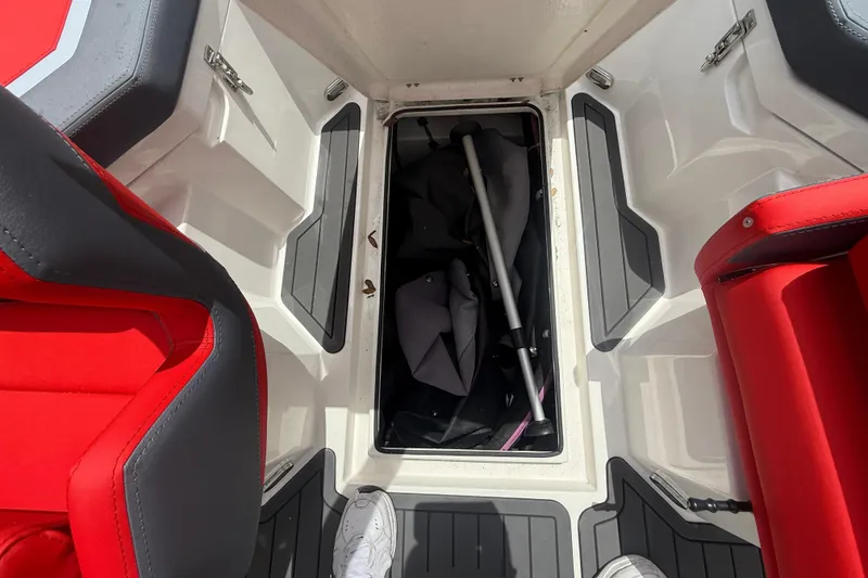 Slide: The Image of Interior of a 2025 Custom DW DESIGN 570BR boat with storage compartment open. - 16