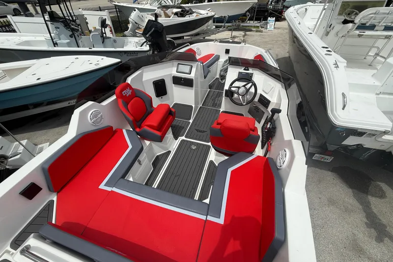 Slide: The Image of Custom DW DESIGN 570BR 2025 boat interior with red seating and modern dashboard. - 17