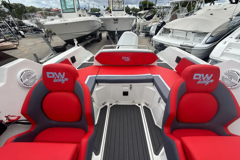 Slide: The Image of Custom DW DESIGN 570BR boat interior with red and gray seating, surrounded by other boats. - 9