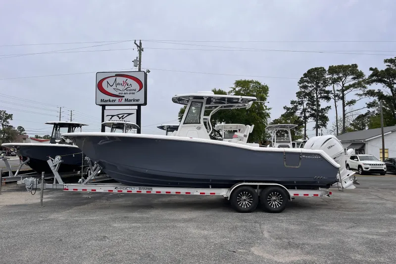 The Image of 2026 Tidewater 282 CC Adventure boat on trailer at Marker 17 Marine dealership. - 1