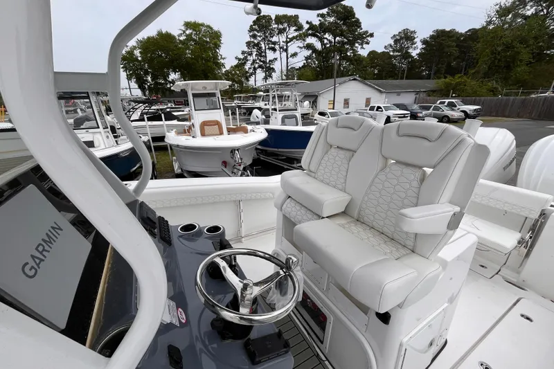 Slide: The Image of 2026 Tidewater 282 CC Adventure boat interior with dual captain's chairs and Garmin navigation. - 10