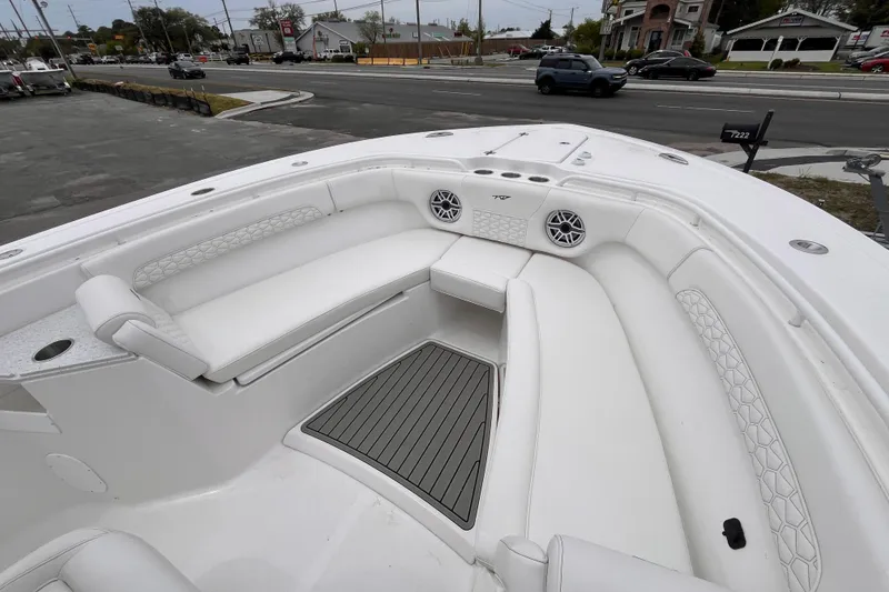 Slide: The Image of 2026 Tidewater 282 CC Adventure boat interior with white seating and speakers. - 14