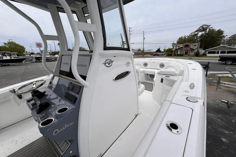 Slide: The Image of 2026 Tidewater 282 CC Adventure boat interior with Garmin electronics and seating area. - 17