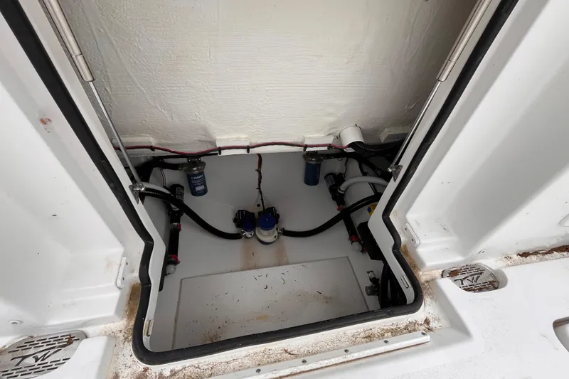 Slide: The Image of Bilge compartment of 2026 Tidewater 282 CC Adventure boat, showing pumps and wiring. - 20