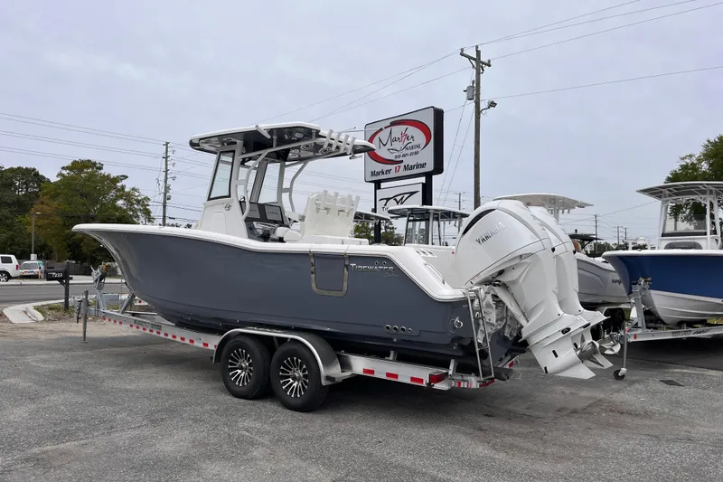 Slide: The Image of 2026 Tidewater 282 CC Adventure boat on trailer at dealership, featuring dual Yamaha engines. - 3