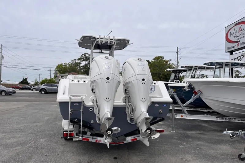 Slide: The Image of 2026 Tidewater 282 CC Adventure boat with dual outboard engines in a marina parking lot. - 4