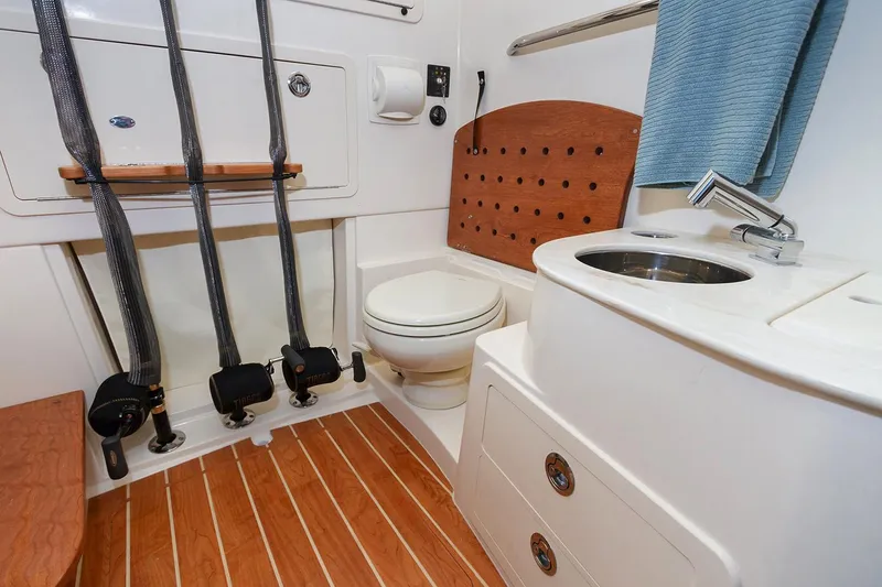 Slide: The Image of Manufacturer Provided Image: 2021 Grady-White Canyon 336 boat bathroom with toilet, sink, and wooden flooring. - 15
