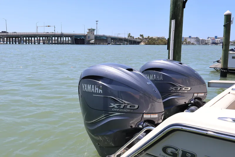 Slide: The Image of Twin Yamaha XTO Offshore engines on a 2021 Grady-White Canyon 336 boat by a bridge. - 19