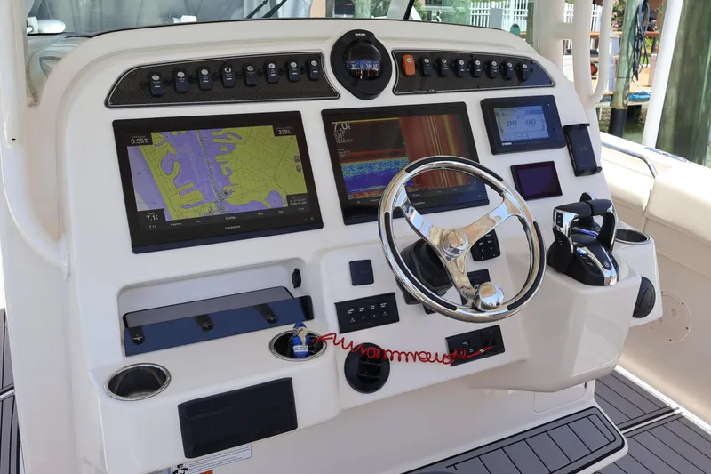 Slide: The Image of 2021 Grady-White Canyon 336 helm with advanced navigation displays and controls. - 23