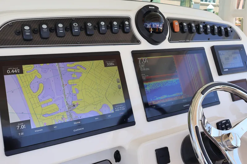 Slide: The Image of Dashboard of 2021 Grady-White Canyon 336 with Garmin navigation displays and controls. - 24