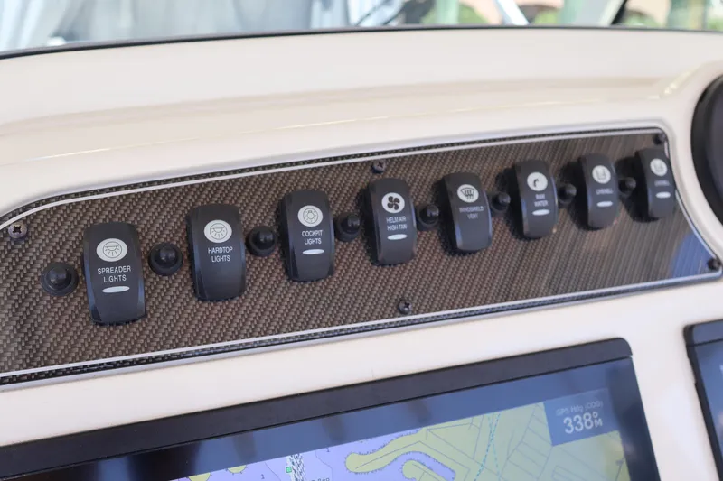 Slide: The Image of Control panel of a 2021 Grady-White Canyon 336 boat with labeled switches. - 26