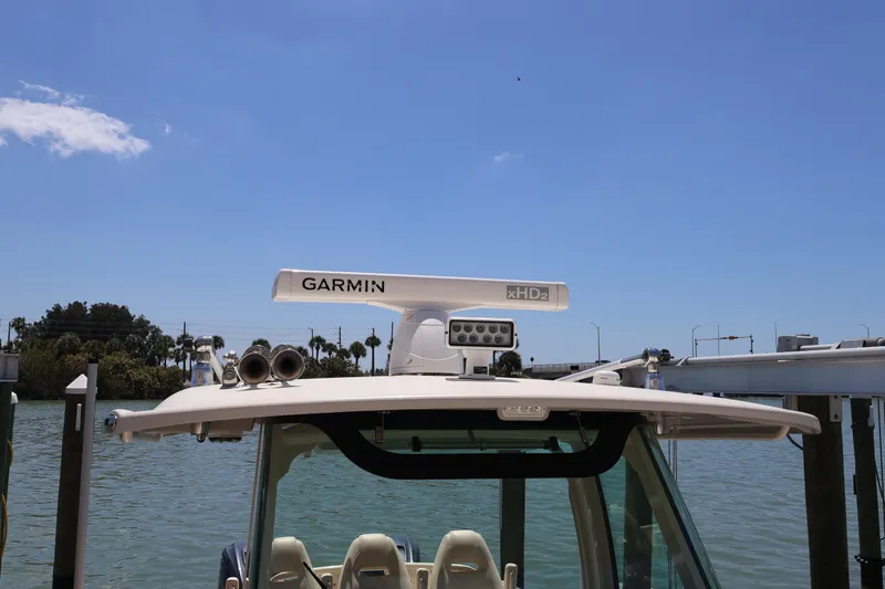 Slide: The Image of 2021 Grady-White Canyon 336 boat with Garmin radar, docked by the water. - 30