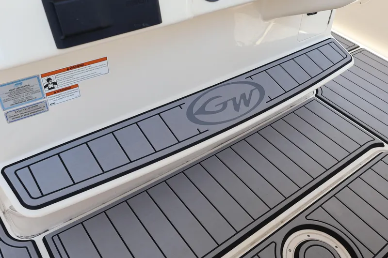 Slide: The Image of 2021 Grady-White Canyon 336 boat deck with GW logo and safety warnings. - 34