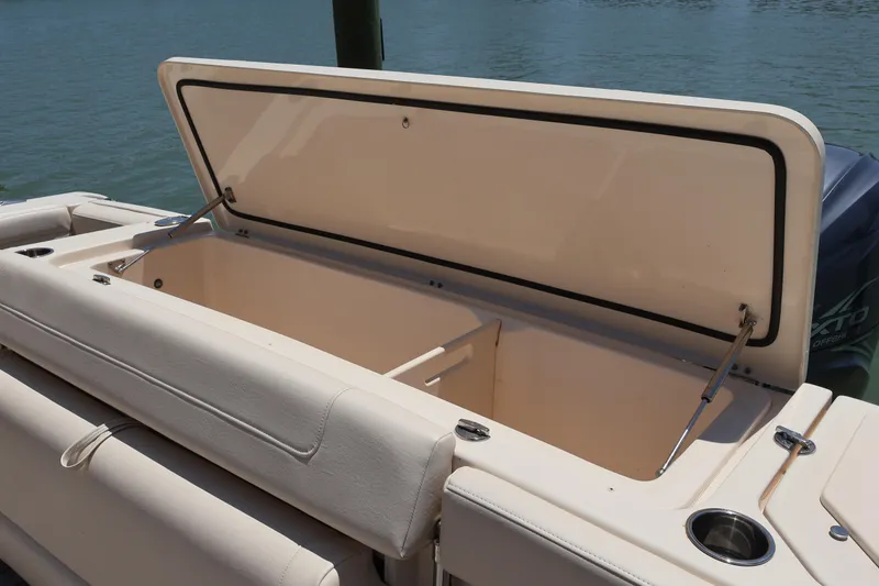 Slide: The Image of Open storage compartment on 2021 Grady-White Canyon 336 boat, docked by the water. - 45