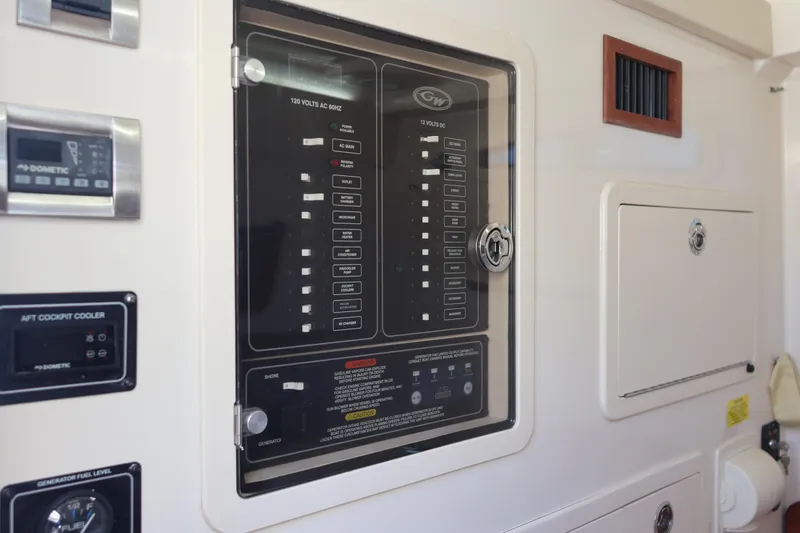 Slide: The Image of Control panel of a 2021 Grady-White Canyon 336 boat, featuring various switches and indicators. - 54