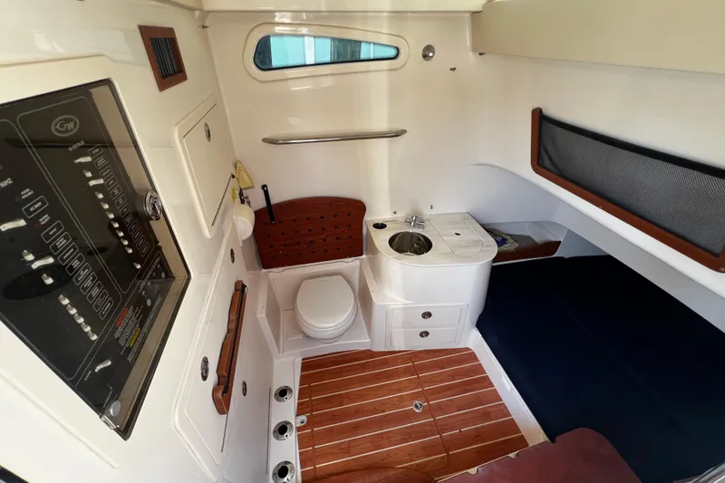 Slide: The Image of 2021 Grady-White Canyon 336 cabin interior with toilet, sink, and control panel. - 59