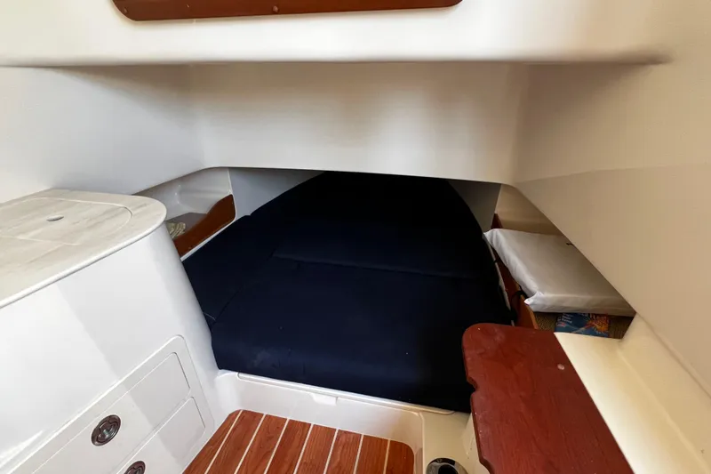 Slide: The Image of 2021 Grady-White Canyon 336 cabin interior with bed and storage compartments. - 60