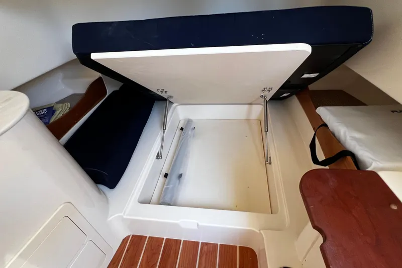 Slide: The Image of 2021 Grady-White Canyon 336 interior storage compartment with open hatch and seating. - 61