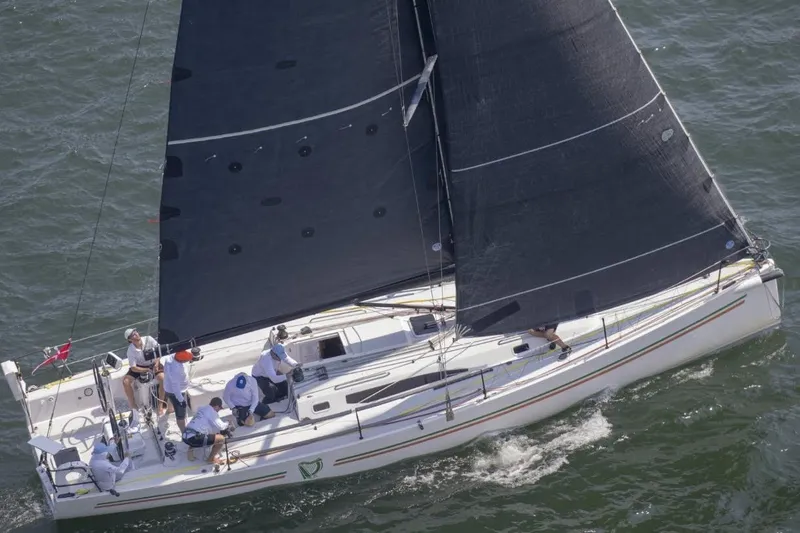Slide: The Image of 2018 J Boats J/121 sailing on open water with crew onboard. - 7