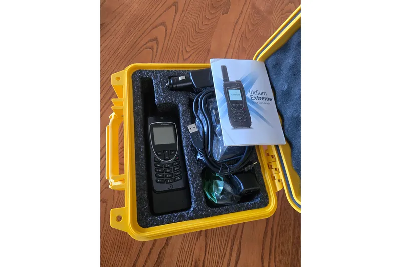 Slide: The Image of Yellow case with Iridium Extreme satellite phone and accessories. - 26